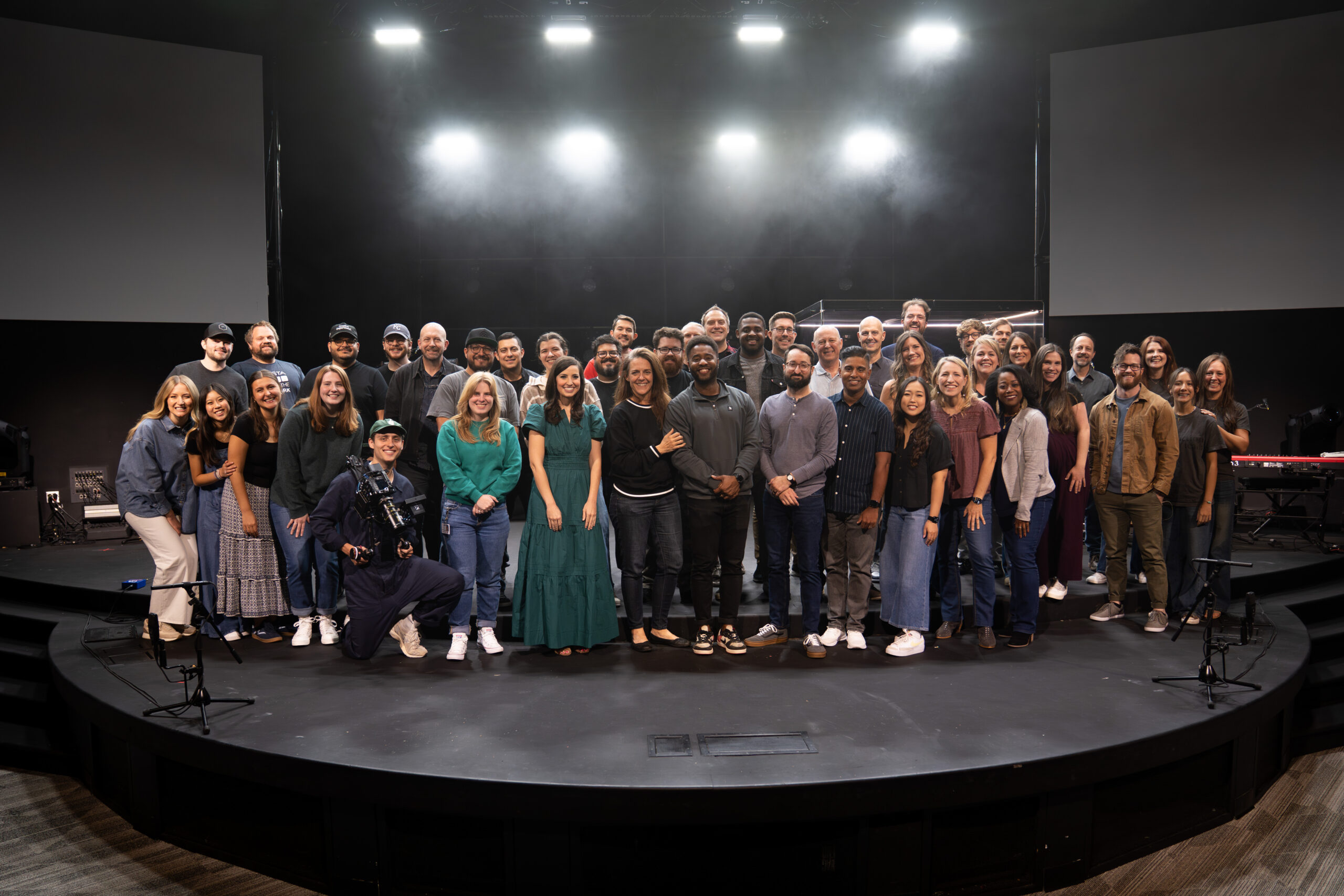 Perimeter Worship's team posing all together for a group photo on stage.